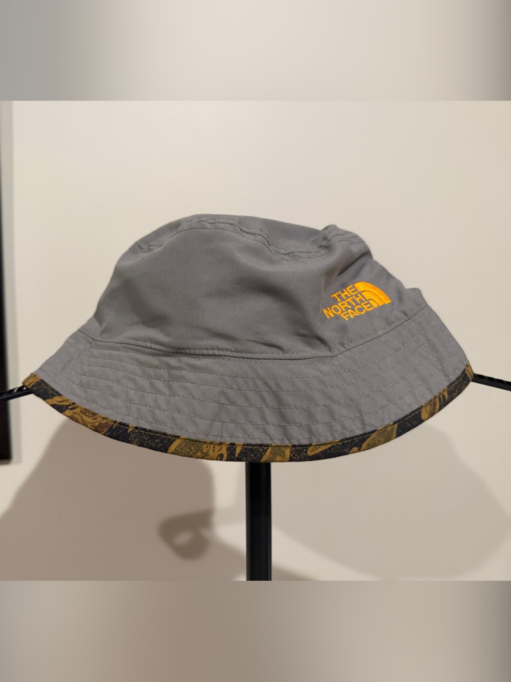 The North Face Reversible Kids Gray Bucket Hat with Orange Logo and Trim